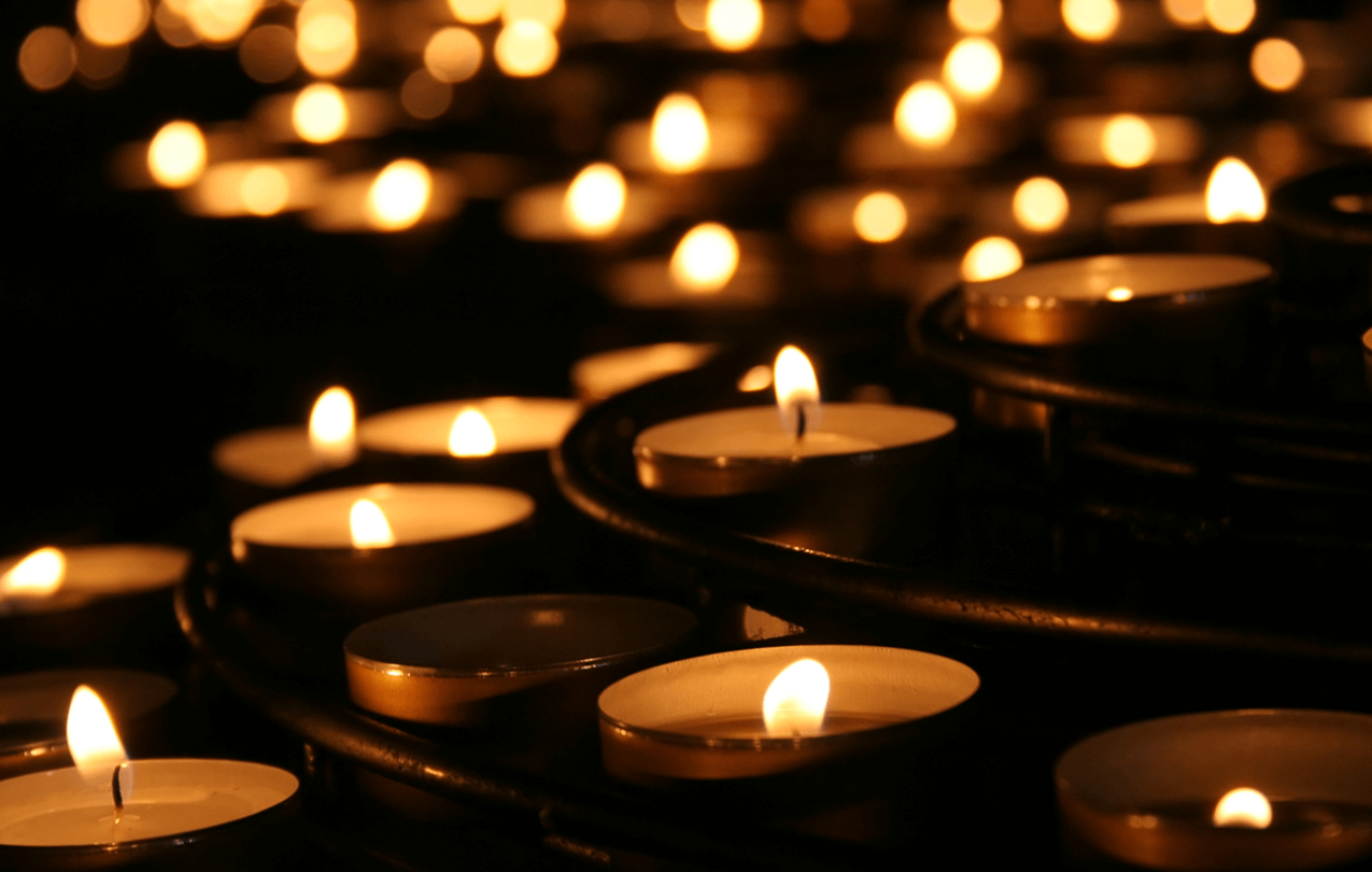 Collection lighted of votive candles for Workers Memorial Day